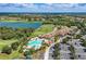 Spectacular aerial view showcasing a pristine lake, a golf course, a swimming pool, and luxurious real estate at 212 River Enclave Ct, Bradenton, FL 34212
