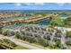 A stunning aerial view of tennis courts, a parking lot, and a luxurious swimming pool in a vibrant community at 212 River Enclave Ct, Bradenton, FL 34212