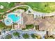 An aerial view showing a stunning building next to a swimming pool area and a golf course on a sunny day at 212 River Enclave Ct, Bradenton, FL 34212