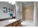 Well-lit bathroom with a modern vanity, framed mirror and a shower-tub combination at 212 River Enclave Ct, Bradenton, FL 34212
