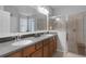 Elegant bathroom with double sinks, granite countertops, and a glass-enclosed shower offers a luxurious feel at 212 River Enclave Ct, Bradenton, FL 34212