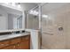 Bathroom featuring a single sink, a large mirror, and a tiled shower which blends functionality with a modern aesthetic at 212 River Enclave Ct, Bradenton, FL 34212