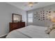 Bright bedroom boasting a ceiling fan, a dresser with a large mirror and a wall adorned with pictures at 212 River Enclave Ct, Bradenton, FL 34212