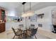 Stylish dining area with a glass table, modern lighting, and open layout at 212 River Enclave Ct, Bradenton, FL 34212