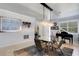 Elegant dining room showcasing a glass table, piano, and contemporary lighting at 212 River Enclave Ct, Bradenton, FL 34212