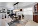 Bright dining room features a glass-top table, piano, and stylish chandelier at 212 River Enclave Ct, Bradenton, FL 34212