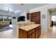Kitchen island featuring granite countertops, cabinets, and access to the living room at 212 River Enclave Ct, Bradenton, FL 34212