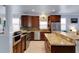 Modern kitchen with stainless appliances, granite counters, and custom cabinetry at 212 River Enclave Ct, Bradenton, FL 34212