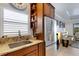 Kitchen with stainless steel appliances, granite counters, and seating area at 212 River Enclave Ct, Bradenton, FL 34212