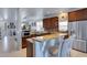 Modern kitchen with granite countertops, stainless appliances, and bar seating at 212 River Enclave Ct, Bradenton, FL 34212