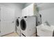 Well-equipped laundry room featuring modern appliances, storage cabinets, and a utility sink at 212 River Enclave Ct, Bradenton, FL 34212