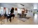 Open-concept living and dining area with a grand piano and stylish decor at 212 River Enclave Ct, Bradenton, FL 34212