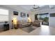 Open living room with neutral decor, tile floors, and sliding door to the lanai at 212 River Enclave Ct, Bradenton, FL 34212
