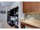 Open-concept nook with a mosaic backsplash, granite counters, and custom cabinets at 212 River Enclave Ct, Bradenton, FL 34212