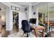 Bright office with a desk, computer, and a view of the balcony and the closet featuring custom organization systems at 212 River Enclave Ct, Bradenton, FL 34212