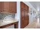 Office nook features granite counters, mosaic backsplash, and custom cabinets at 212 River Enclave Ct, Bradenton, FL 34212