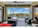 Inviting patio with comfortable seating, a fire pit, and scenic views of the pool and waterway at 212 River Enclave Ct, Bradenton, FL 34212