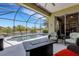 Beautiful patio with seating, a fire pit and gorgeous views of the pool, waterway and surrounding landscape at 212 River Enclave Ct, Bradenton, FL 34212
