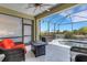 Relaxing patio area with comfortable seating, a fire pit, and a view of the pool and garden at 212 River Enclave Ct, Bradenton, FL 34212