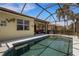 A screened-in pool is nestled next to the home with access to a covered patio at 212 River Enclave Ct, Bradenton, FL 34212