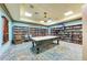 Inviting recreation room featuring a pool table, bookshelves, and comfortable seating for leisure and entertainment at 212 River Enclave Ct, Bradenton, FL 34212