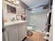 Well-lit bathroom features a walk-in shower with glass doors and a white vanity with clean lines at 2207 Sunset Dr # E5, Bradenton, FL 34207