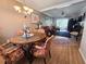 Inviting dining room with elegant chandelier, wooden floors, and seamless transition to living area at 2207 Sunset Dr # E5, Bradenton, FL 34207