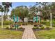 Community picnic and barbeque area at Friendship Square, surrounded by mature trees and lush landscaping at 2207 Sunset Dr # E5, Bradenton, FL 34207