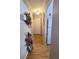 Inviting hallway with wood flooring and tasteful decorations leading to the kitchen at 2207 Sunset Dr # E5, Bradenton, FL 34207