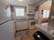 Bright kitchen with white appliances, updated countertops, and convenient layout for cooking at 2207 Sunset Dr # E5, Bradenton, FL 34207