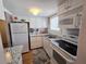 Efficient kitchen featuring stainless steel appliances, granite countertops, and ample cabinet space at 2207 Sunset Dr # E5, Bradenton, FL 34207