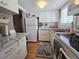 Well-lit kitchen featuring white cabinets, granite countertops, and stainless steel appliances at 2207 Sunset Dr # E5, Bradenton, FL 34207