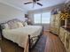 Comfortable bedroom with a ceiling fan, large window, and an ornate, dark-colored metal frame bed at 2207 Sunset Dr # E5, Bradenton, FL 34207