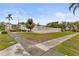 Community pool area with lush landscaping, white fencing, and ample space for relaxation and recreation at 2207 Sunset Dr # E5, Bradenton, FL 34207