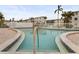 Community pool with inviting blue water, surrounded by lush landscaping and ample seating for residents at 2207 Sunset Dr # E5, Bradenton, FL 34207