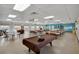 Spacious recreation room with tables, chairs, and a pool table for community enjoyment at 2207 Sunset Dr # E5, Bradenton, FL 34207