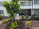 Cozy condo featuring a charming landscaped yard with lush greenery and a private balcony at 2207 Sunset Dr # E5, Bradenton, FL 34207