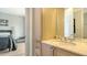 Bathroom with marble countertop sink and cabinets with a view to the bedroom at 235 Cocoanut Ave # 108B, Sarasota, FL 34236