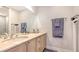 Bright bathroom featuring double sinks with marble countertop and decorative fixtures at 235 Cocoanut Ave # 108B, Sarasota, FL 34236