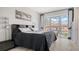 Stylish bedroom with large windows providing an attractive city view and light hardwood flooring at 235 Cocoanut Ave # 108B, Sarasota, FL 34236