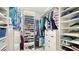 Well-organized walk-in closet with custom shelving and ample storage space for clothes and shoes at 235 Cocoanut Ave # 108B, Sarasota, FL 34236