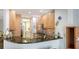 Contemporary kitchen featuring sleek granite countertops, modern appliances, and bright lighting at 235 Cocoanut Ave # 108B, Sarasota, FL 34236