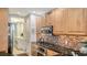Open kitchen with granite countertops, stainless steel appliances, wood cabinets, and adjacent laundry area at 235 Cocoanut Ave # 108B, Sarasota, FL 34236