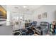 Open concept living room with an outdoor view with leather chairs and hardwood floors at 235 Cocoanut Ave # 108B, Sarasota, FL 34236