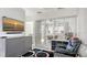 Comfortable living room featuring a modern entertainment center and sliding door access to the patio at 235 Cocoanut Ave # 108B, Sarasota, FL 34236