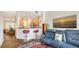 Living room area adjacent to kitchen with wood floors, red chairs, and blue leather couch at 235 Cocoanut Ave # 108B, Sarasota, FL 34236