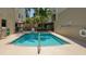 Relaxing community pool and deck with surrounding landscaping and buildings at 235 Cocoanut Ave # 108B, Sarasota, FL 34236
