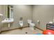 Bathroom featuring toilet, urinal, and a pedestal sink at 235 Cocoanut Ave # 108B, Sarasota, FL 34236