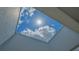 Skylight view of blue sky with puffy white clouds and bright sunshine at 235 Cocoanut Ave # 108B, Sarasota, FL 34236