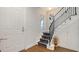 Elegant staircase with black iron railings and patterned carpet, leading to the upper level at 235 Cocoanut Ave # 108B, Sarasota, FL 34236